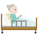 ベッドで上体を起こしてリモコンを操作する高齢者の女性1