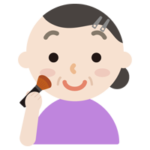 頬紅を塗る中年の女性